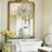 Amy-Morris-empire-tub-e1280150226603 A bath renovation by Amy Morris features the Empire tub and a grand gold leaf mirror in a traditional paneled space. The scale of the mirror and the glittery chandelier add richness and elegance to this luxurious bath.