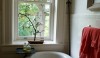 The little arched window lets in the lovliest stream of light. The view from the tub is of ancient tree tops.