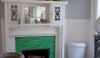 The original fireplace with shaded bright green 1 x 6 ceramic tile that looks like the material made by the J. & G. Low Company of Trenton, NJ in the early 20th century.