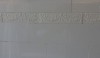 Creamy white tile with a very subtle decorative border and a simple bullnose is used in all of the baths.