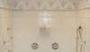 Another great full throttle shower with a wire basket and fold-up seat plus two thermostatic shower valves to operate the many options in this shower. Don't you love the beautiful mosaic frieze?