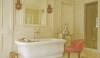 trad-home-may-2010-e1280159321453 The red chair is a great addition to this space for chatting with a partner while adding color, comfort and decoration to the bath.