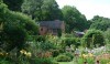 gardens_5-e1280505770174 A view from the garden to the rear of the house. You can see the brick addition to the house for more modern living and the lovely red barns in the distance.
