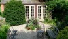 shed-e1281100869809 Another beautiful space, this one with a pea gravel platform and traditional outbuilding for storage of garden tools.