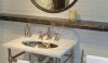 This is a great use of ceramic tile in a display at Waterworks 58th Street Showroom in New York City. The wall material is the unusual 2" x 12", the shelf has a bold ceramic molded edge and the mirror is surrounded by custom shaped ceramic molding. The shelf and mirror are a lustrous pewter glaze.