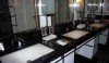 There are many nickel details combined with white glass in the sophisticated black and white ladies room at the London Hotel. The rectangular sinks along with other design details make the space feel crisp and modern.