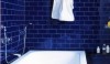These deep blue tiles are dust pressed and have perfectly square edges. They are set with tight grout joints. The silver gray grout adds just enough contrast.
