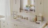 The simplicity of the metal framed medicine cabinet allows the sconces to be the stars. I like the double arms and silk shades. They add a bit of formality to the bath.