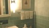 I love this double Opus light installed vertically. However, you can see that the light creates a "hot spot" on the wall. The bath looks a little more balanced when the light is spread evenly over the wall.