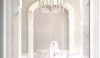 Lux_Bath_081 This delicate pink chair graces the bath of author and designer, Betty Lou Phillips, in Dallas. It is created in fine dressmaker fashion with covered buttons on the back and deep inverted pleats all around. It is decorative and comfortable.