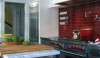 Backsplash This red backsplash is a bold statement. It looks great with the red knobs on the Wolf range, the stainless appliances and island, and Cararra counter tops.