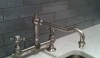 Backsplash10 The textured face of Whickham Blue Grove Brickworks is a lovely compliment to the matte nickel kitchen fitting. It is set with Silver Shadow grout. This particular choice of grout is complimentary to the gray tones in the Cararra countertop. The choice of grout can completely change the look of the tile.