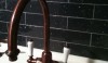 Backsplash9 Dark backsplashes are dramatic; this one is Dark Naval Blue in the Grove Brickworks collection. The aged copper bar fitting looks great aginst the color.