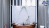 PerfectBath.com_Backsplashes_1 The book matched marble with faint green veining is a great backsplash for a copper free standing tub. It adds a counterpoint to the bold black and white striped wallpaper and is practical when the hand shower is used.