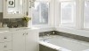 backsplash12 The continuation of gray tile from the cladding of the tub box to the backsplash around the tub and vanity creates visual harmony in the bath.