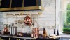 Betty_Lou2 The kitchen is ideal for creating fabulous meals. The handsome La Cornue range is as beautiful as it is functional. Copper pots, oversized culinary utensils, soapstone countertops with shaped edges, and a Calcatta backsplash in an elongated shape complete the picture of an enviable kitchen.