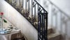 Betty_Lou4 The stair railing, made by skilled craftsman, uses subtle burnished flourishes. This graceful design accents the sweeping stair to the second floor.