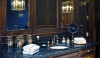 Betty_Lou5 Mr. Phillips' bathroom is the epitome of masculinity; rich mahogany cabinetry and paneling, Nero Marquina marble counters and floors, and unlaquered brass fittings reminiscent of old luxury liners.