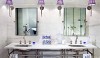 Betty_Lou9 A double washstand set against marble walls. The room is softened by the elegant sconces with the custom lavendar shades.