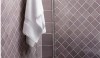 Ceramic-Tile003-e1298676704169 A soft shade of heather called Crepe, 3x3 tiles set on the diagonal, a border row of 6x6 and a decorative border give the panel structure.