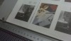 Inspecting the pages as they come off the press for color and clarity.