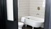 ace-hotel-new-york-Remodelista-2-e1299871204446 6 x 6 ceramic tile set in a brick bond pattern with Silver Shadow grout. The light gray defines the grid.