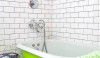 emily-henson-bath_Remodelista-e1299871217825 A simple 3 x 6 ceramic tile brick using a light gray grout. The grid gives this simple space definition. Also note the black grout on the Penny tile on the floor. The result would have been entirely different if white grout had been used.