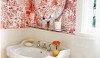 House Beautiful_Wallpaper Red and white makes for a very cheerful and welcoming powder room.