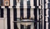 Lonny - Striped Powder Room Wallpaper The vertical stripes from floor to ceiling make the space feel enclosed.