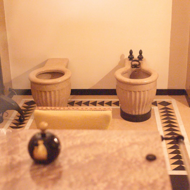 L1001890 The water closet and bidet sculpted out of the same hauteville as the rest of the suite.