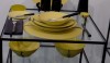 Muriel-Grateau3 This is certainly one of her boldest place settings in bright yellow with artistic spatter decoration. Can you imagine the food that would look tempting on this dinner plate. The dark gray napkin adds subtlety to the arrangement.