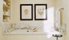 This entire space is traditional and tidy. The 2 pictures over the tub draw your eye to the wall and convey a message that this is a traditional space.
