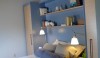 L1020452 The upstairs bedroom with built-in cabinetry, well thought out display space or book shelves, and convenient placement of lights. The color is soothing as well.