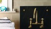 mixer_HR_flat A laundry tub made from soapstone with a grooved facade that adds color and texture. The brass bolts and wall mounted Easton fitting compliment the dark stone. The unlacquered brass will develop a patina in time.