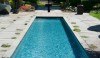 The reflecting pool just behind the house in a refreshing clear blue.