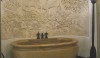 20110718131554546 A large and luxurious bathtub carved from a single block of French marble with a magnificent bas relief as its background. We often talk about texture on the wall and this is a remarkable example.