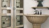 20110718131630964 The well-formed pedestal sink with storage in the background with glass front doors. Mirrors were used to visually expand the space.