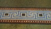 Neues Museum. An elaborate Greek key in bright colors. It appears that this border is set in the restoration of the cement floor.