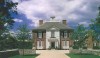 The completed facade with an elegant alley of trees leading up to the gracious entrance.