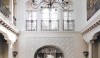 The atrium of the Palm Beach house with a new second floor balcony overlooking the pool.