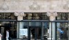 Shop Entries A view of the facade highlighting the beautiful terra cotta decoration with transparent glass shop entries.