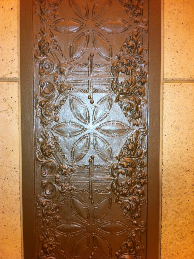 Embossed Metal Panels In typical Louis Sullivan fashion, a number of embossed metal panels are embedded in the stone walls.