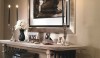 On the Christian Astuguevielle console table are a pair of Georg Jensen candelabras that flank an oil on hand-made paper nude. This vignette displays the strong choices made for this apartment.