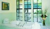Architectonics_Gast Architects_Houzz A lovely installation of soft green hand-made tiles with transparent glaze. The tile is complimented by the decorative mosaic border and the herringbone pattern on the floor.