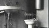 In one of the bathrooms, the bidet and the cupboard above it swivel. The exposed piping was deliberately left  visible.