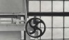 This industrial looking wheel controls the ventilating system. Its' handsome silhouette is enhanced against the glass blocks that form the exterior of the house.