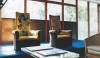 The sitting room or salon of Mrs. Dalsace, where she entertained her guests, overlooked the garden. The blue carpet and tapestry fabric on the  upholstered furniture add unexpected color to the interior.