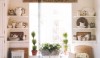 This kitchen is warm and friendly with collections of white china and silver within easy access.  Open displays are old fashioned but the combination of collections is artful.
