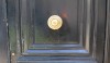 A large scale single brass knob nestled in a raised panel feels like the right scale.