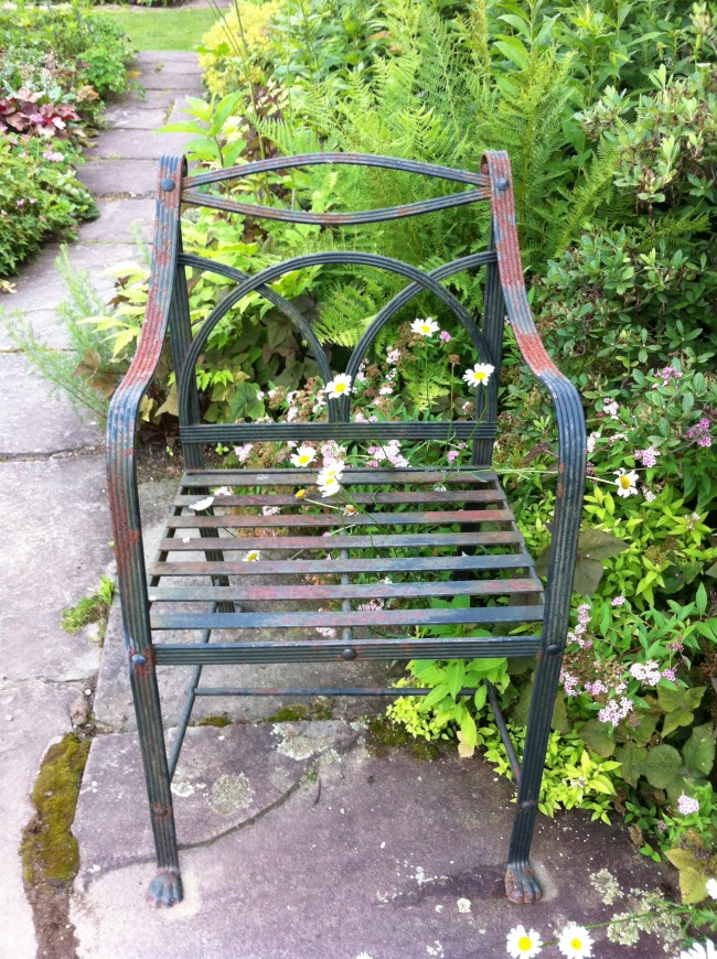 IMG_1427 The weathered stones and the worn finish on the chair are complimentary.